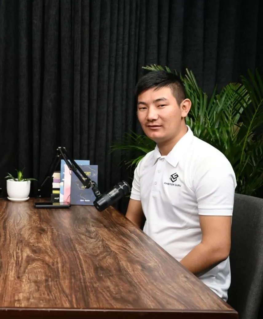 Dawa Sherpa at a studio table with a microphone