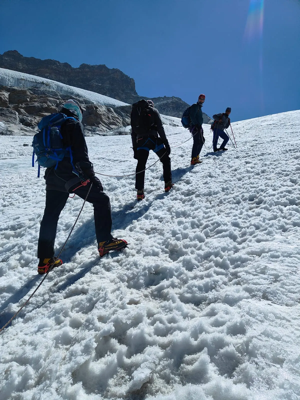 Climbers in a line ascending a snow slope